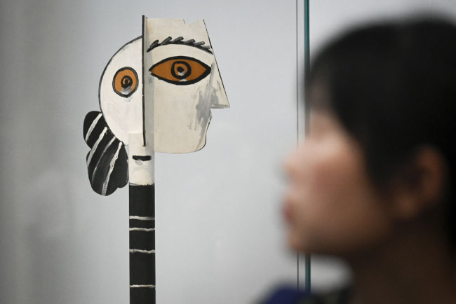 This picture taken on June 14, 2019 shows a painted and cut wood entitled "Head of Woman" by Pablo Picasso during an exhibition "Picasso Birth of a Genius" at an art gallery in Beijing. [Photo: AFP/Wang Zhao]