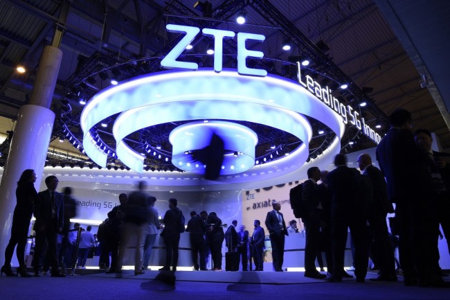 People walk past the ZTE stand at the Mobile World Congress (MWC) in Barcelona on February 25, 2019. [Photo: AFP]