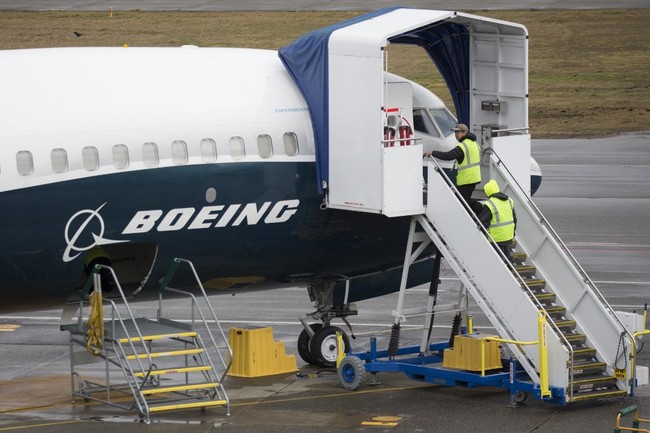 In this file photo taken on March 12, 2019 workers are pictured next to a Boeing 737 MAX 9 airplane on the tarmac at the Boeing Renton Factory in Renton, Washington. [Photo: AFP]