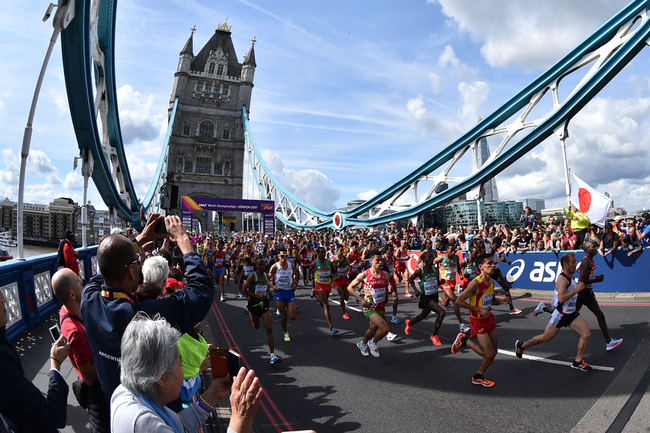 In this file photo taken on August 6, 2017 athletes depart from Tower Bridge at the start of the men's marathon athletics event at the 2017 IAAF World Championships in central London. London's iconic Tower Bridge celebrates its 125th anniversary on Sunday by showing off the weird and wacky alternative designs that were nearly built instead.[Photo: AFP/Glyn KIRK]