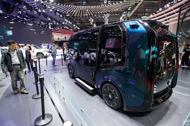 Visitors look at a minibus developed by Huawei and Dongfeng Motor at the 18th Shanghai International Automobile Industry Exhibition on April 20, 2019. [Photo: VCG]