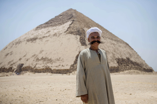 A man stands in front of the Bent Pyramid of Sneferu that was reopened after restoration work, in Dahshur, some 40kms south of Cairo, Egypt, July 13, 2019. The Bent Pyramid is one of three pyramids built by King Sneferu during Old Kingdom era (2600 BC) and represents a unique example of early pyramid development construction in Egypt. [Photo: IC]