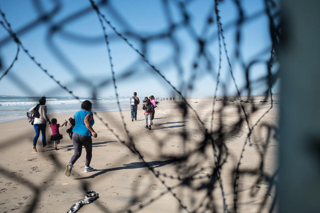 After slipping through a small hole in the border wall dividing the United States and Mexico, asylum seekers run onto American soil. While some people were caught, border patrol was overwhelmed by the mass group crossing and were unable to arrest everyone initially. In February 2019, around 76,000 fled from the southern border into the United states in order to find a better life. [Photo: IC]