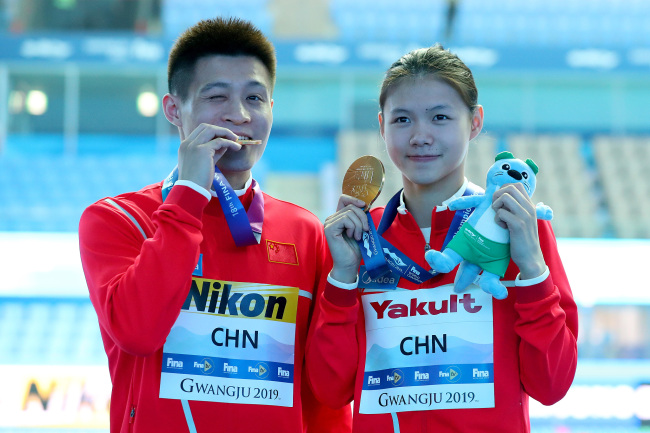 China’s gold medalists Yang Jian and Lin Shan pose during the medal ceremony for the mixed team event final on day five of the Gwangju 2019 FINA World Championships at Nambu International Aquatics Centre on July 16, 2019 in Gwangju, South Korea. [Photo: VCG/Getty Images/Maddie Meyer] 