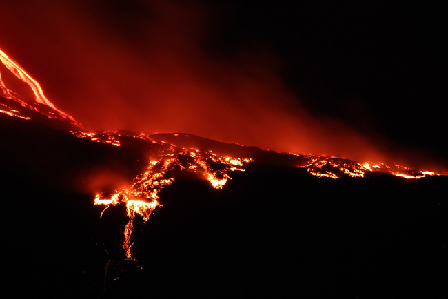 Mt. Etna continues the lively Strombolian activity of the New South East Crater, which has generated a long lava flow, which flows from the valley of the Bove, on the east coast of Sicily, Italy, on Saturday, July 20, 2019. [Photo: IC]