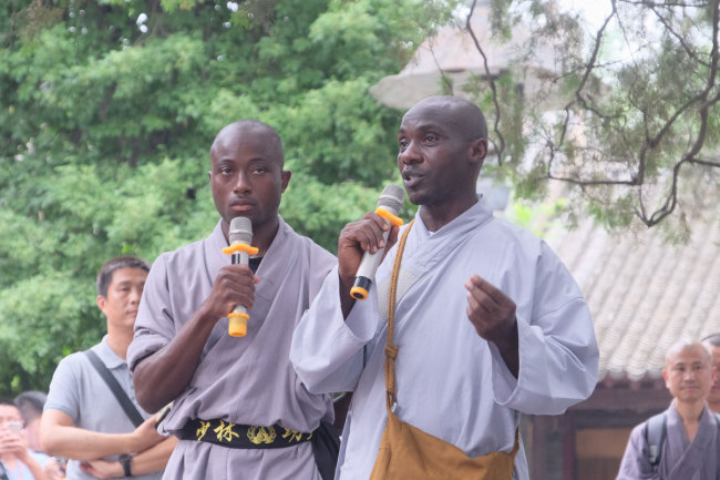 Representatives(代表) of the African apprentices deliver a speech(演讲) during the opening ceremony of the seventh Shaolin Martial Art African Apprentice Class on Monday, July 22, 2019. [Photo: IC]