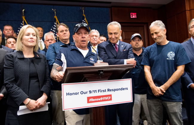 9/11 first responder John Feal, stands with Senate Minority Leader Charles Schumer, D-NY, Sen. Kirsten Gillibrand, D-NY, and John Stewart, 9/11 rights activist, at a press conference on the passage of the 9/11 Victim Compensation Fund extension, on Capitol Hill in Washington, D.C. on July 23, 2019. [Photo: UPI via IC/Kevin Dietsch]