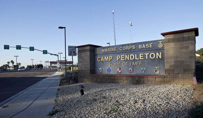 This Nov. 13, 2013 file photo shows the main gate of Camp Pendleton Marine Base at Camp Pendleton, Calif. A human smuggling investigation by the military led to the arrest of 16 Marines Thursday, July 25, 2019 while carrying out a battalion formation at California's Camp Pendleton, a base about an hour's drive from the U.S.-Mexico border. [File Photo: AP Photo/Lenny Ignelzi]