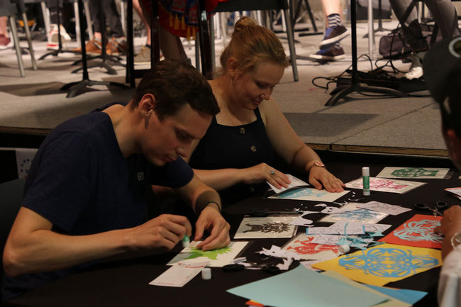 Folk artists make paper cutting at the "EU-China Youth Music & Art Festival 2019" in Zandhoven, north Belgium, July 27, 2019. [Photo: China Plus]