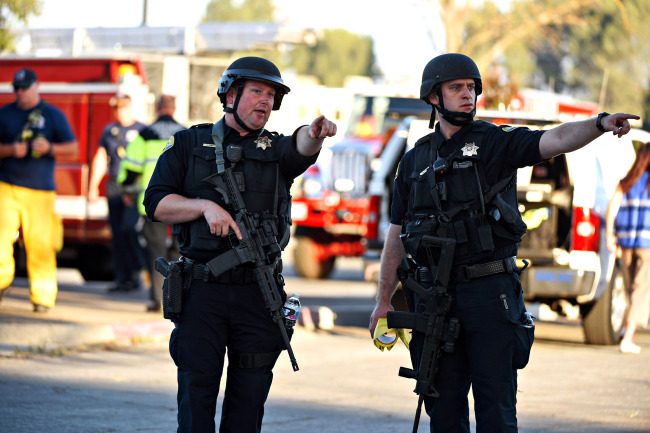 Armed police on the scene of a shooting during the Gilroy Garlic Festival along Miller Avenue near Gilroy High School. [Photo: San Francisco Chronicle/Polaris via VCG/Cody Glenn]