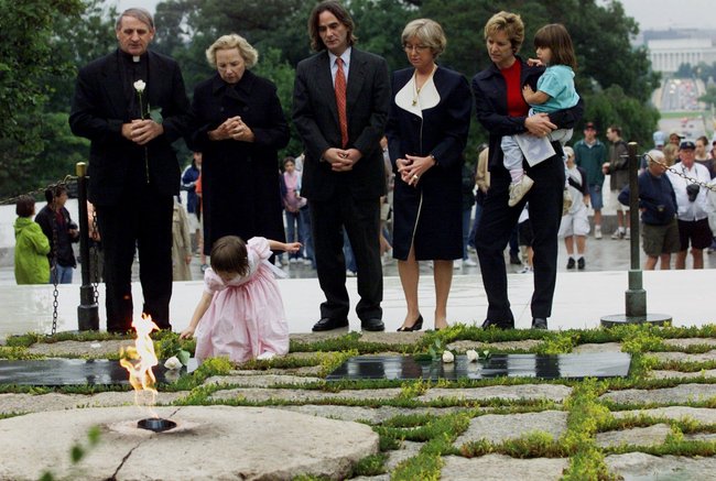 In this June 6, 2000 file photo, Robert F. Kennedy's granddaughter Saoirse Kennedy Hill places a white rose at the Eternal Flame, President John F. Kennedy's gravesite, at Arlington National Cemetery in Arlington, Va. Hill, has died at the age of 22. The Kennedy family released a statement on Thursday night, Aug. 1, 2019, following reports of a death at the family's compound in Hyannis Port, Massachusetts. Hill was the daughter of Robert and Ethel Kennedy's fifth child, Courtney, and Paul Michael Hill. [File Photo: AP/Hillery Smith Garrison]