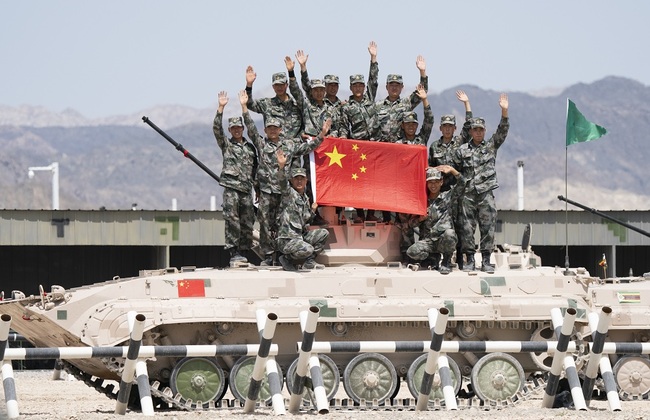 A group of Chinese soldiers pose for a picture with the Chinese national flag on an 86A Infantry Fighting Vehicle after the "Suvorov Attack" contest of the International Army Games 2019 in Korla City in Xinjiang Uygur Autonomous Region, China on August 4, 2019. The Chinese army has taken part in the games since 2014 and hosted them first time in 2017. [Photo: The Beijing News via IC]