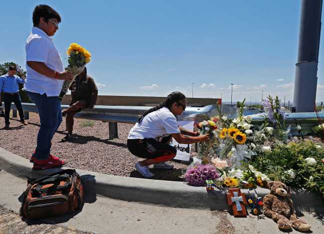 People lay flowers at a make shift memorial along the street behind the scene of a mass shooting at a Walmart in El Paso, Texas, 04 August 2019. [File Photo: EPA via IC/Larry W. Smith]