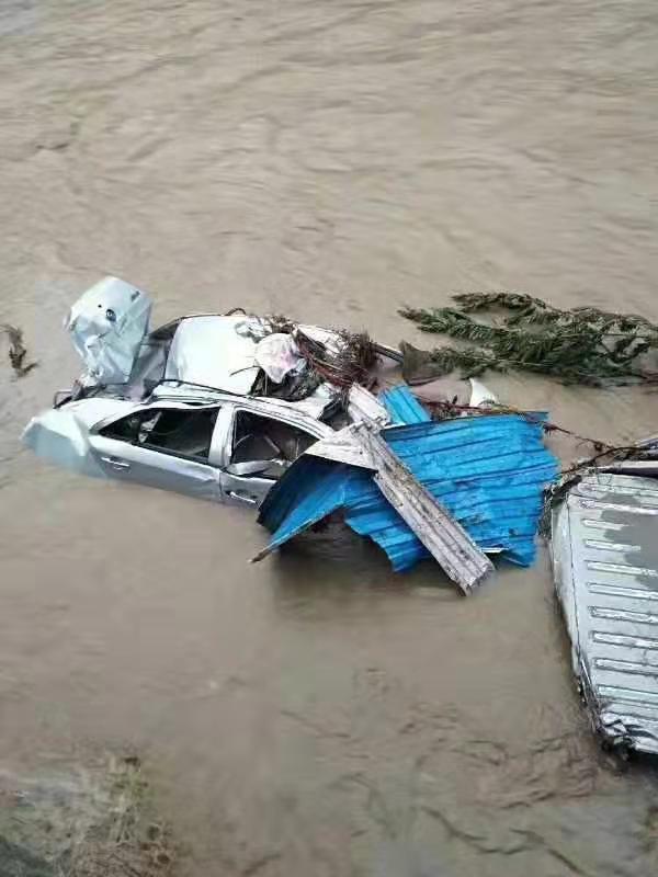 A car is submerged by floodwater after heavy downpours in Shiyan city, central China's Hubei province, August 3, 2019. [Photo: IC]