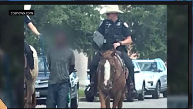 A black suspect was tied with a rope by two of officers riding on horseback last Saturday, Aug 3, 2019.[Screenshot taken from CBS news video]