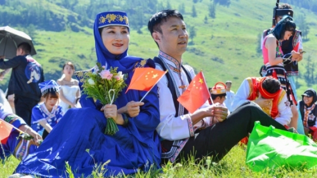 People attend a group wedding at the Kanas Scenic Area in Altay, northwest China's Xinjiang Uygur Autonomous Region, on July 1, 2019. [Photo: IC]