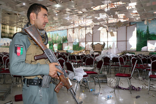 An Afghan security official stands guard after an overnight suicide bomb blast that targeted a wedding reception in Kabul, Afghanistan on August 18, 2019. [Photo: Anadolu Agency via Getty Images via VCG/Haroon Sabawoon]