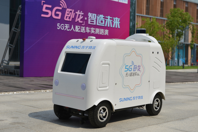 An unmanned 5G delivery vehicle developed by Suning, one of China's largest retailers, is tested on the road in Nanning, Jiangsu Province, on Saturday, August 17, 2019. [Photo: VCG]