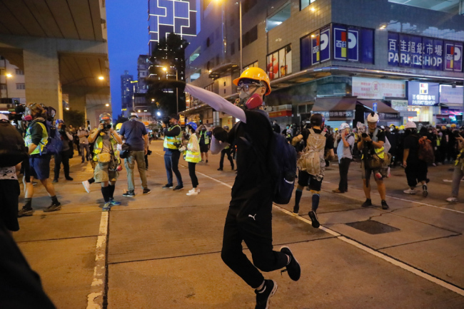A protester throws an egg during a protest march in Hong Kong Saturday, Aug. 17, 2019. [Photo: AP]