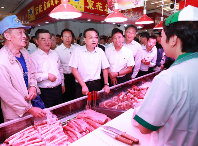 Chinese Premier Li Keqiang visits a farm-produce market in Harbin, capital of Heilongjiang, during his inspection tour in northeast China's Heilongjiang Province from Monday to Tuesday. [Photo: gov.cn]