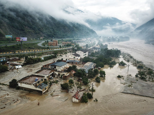 Roads and residential buildings are devastated by multiple mudslides triggered by heavy rainfall in Wenchuan County, Aba Tibetan and Qiang Autonomous Prefecture, Sichuan Province on August 20, 2019. [Photo: IC]