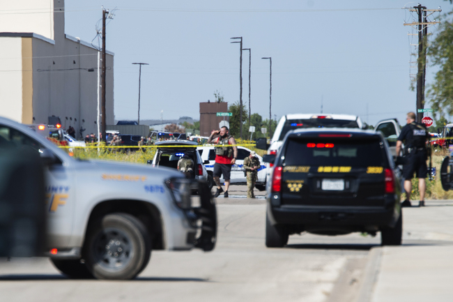 Odessa and Midland police and sheriff's deputies surround the area behind Cinergy in Odessa, Texas, Saturday, Aug. 31, 2019, after reports of shootings. Police said there are "multiple gunshot victims" in West Texas after reports of gunfire on Saturday in the area of Midland and Odessa. [Photo: AP/Tim Fischer/Midland Reporter-Telegram]