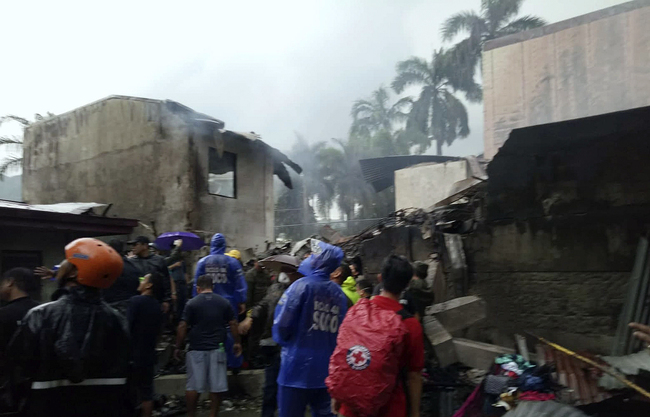 In this photo provided by Philippine Red Cross, rescuers look at the site where a plane crashed in Laguna, south of Manila, Philippines on September 1, 2019. [Photo: Philippine Red Cross via AP]