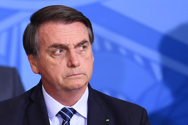 Brazilian President Jair Bolsonaro looks on during the launching ceremony of the Front Brazil Project, which aims at reducing the rates of violence in cities, at Planalto Palace in Brasilia, on August 29, 2019. [Photo: EVARISTO SA/AFP]