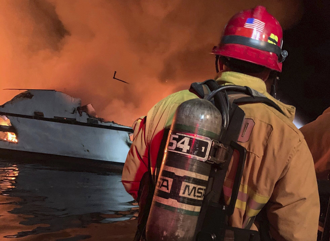 In this photo provided by the Ventura County Fire Department, VCFD firefighters respond to a boat fire off the coast of southern California, Monday, Sept. 2, 2019. The U.S. Coast Guard said it has launched several boats to help over two dozen people "in distress" off the coast of southern California. [Photo: Ventura County Fire Department via AP]