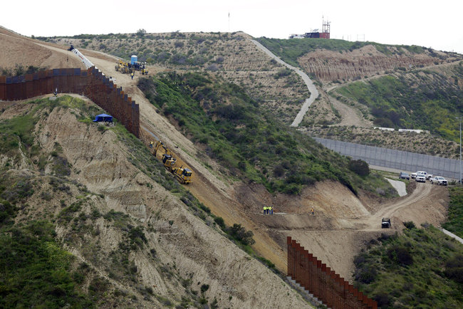 In this March 11, 2019 photo, construction crews replace a section of the primary wall separating San Diego, above right, and Tijuana, Mexico, below left, seen from Tijuana, Mexico. [File photo: AP]