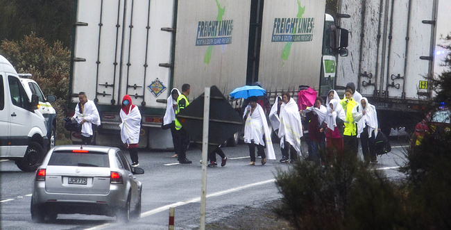 Survivors from a tourist bus crash walk along the highway in the Mamaku Ranges near Rotorua, New Zealand, Wednesday, Sept. 4. 2019. [Photo: AP/ Rotorua Daily Post /Ben Fraser]