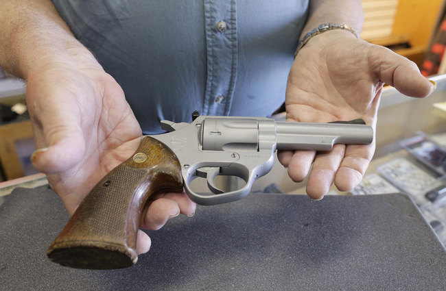 George Bramlett, owner of the Bargain Pawn shop holds former LAPD police officer Christopher Dorner's Astra 960 .38 Special revolver, Friday, April 12, 2013, in Las Vegas. [Photo: AP]