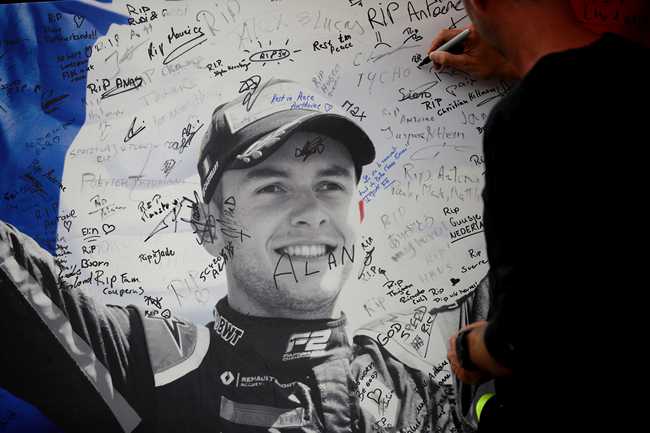 A man signs a remembrance board for Formula 2 driver Anthoine Hubert at the Belgian Formula One Grand Prix circuit in Spa-Francorchamps, Belgium, Sunday, Sept. 1, 2019. The 22-year-old Hubert died Saturday following an estimated 160 mph (257 kph) collision on Lap 2 at the high-speed Spa-Francorchamps track, which earlier Saturday saw qualifying for Sunday's Formula One race. [Photo: AP/Francisco Seco]