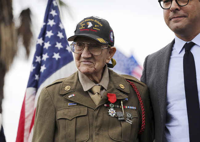 In this Sept. 19, 2017, file photo, U.S. Army Pvt. Henry L. Ochsner is awarded the National Order of the Legion of Honor (Légion d'Honneur), the French government's highest honor, from Christophe Lemoine, France Consul General in Los Angeles, during a ceremony at Los Angeles National Cemetery. World War II veteran Henry Ochsner, who landed on the beach at Normandy on D-Day and later received the French government's highest honor for his service, has died. He was 96. [File Photo: AP/Reed Saxon]