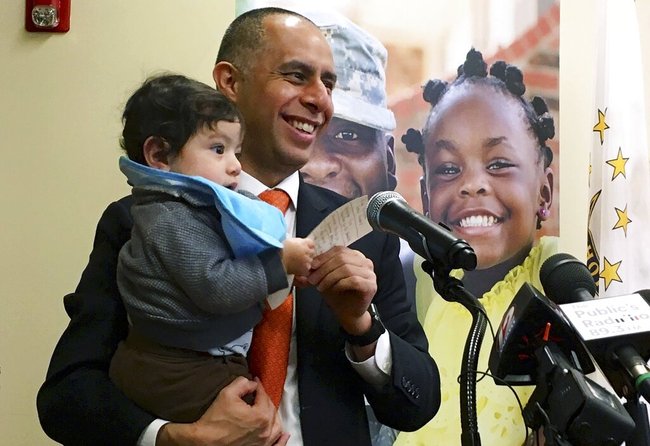 In this March 20, 2019, photo, Mayor Jorge Elorza holds his son Omar during a news conference in Providence, R.I. [File photo: AP]