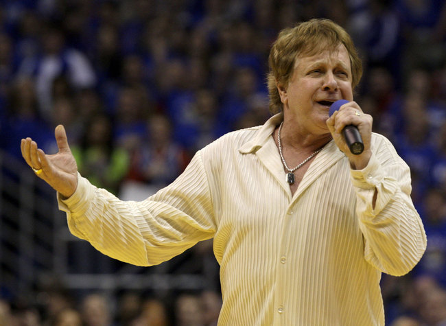 In this Jan. 25, 2010 file photo, Eddie Money sings the national anthem before an NCAA college basketball game between Kansas and Missouri in Lawrence, Kan. [Photo: AP]