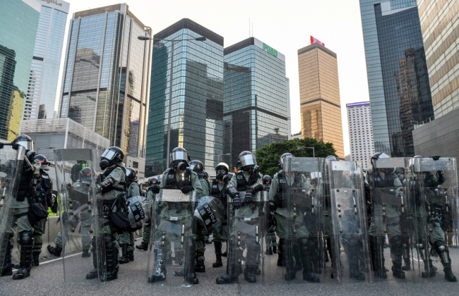 Hong Kong police prepare to disperse the protesters outside the government headquarters in the Hong Kong Special Administrative Region on September 15, 2019. [Photo: AFP]