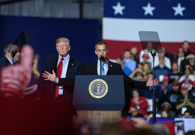 Former Trump Campaign manager Corey Lewandowski speaks as U.S. President Donald Trump looks on during a rally at Total Sports Park in Washington, Michigan on April 28, 2018. [File Photo: AFP]