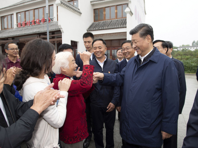 Chinese President Xi Jinping, also general secretary of the Communist Party of China Central Committee and chairman of the Central Military Commission, talks with locals at a village in Guangshan County, Henan Province on September 17, 2019. [Photo: Xinhua]