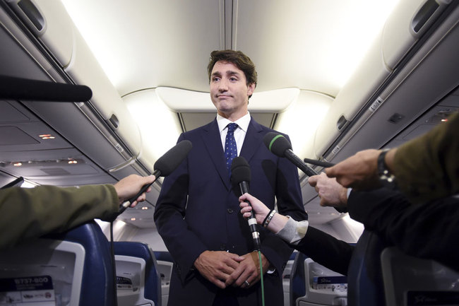 Canadian Prime Minister and Liberal Party leader Justin Trudeau makes a statement in regards to a photo coming to light of himself from 2001, wearing "brownface," during a scrum on his campaign plane in Halifax, Nova Scotia, Wednesday, Sept. 18, 2019. [Photo: The Canadian Press via AP via IC/Sean Kilpatrick]