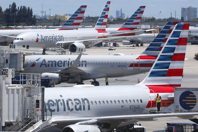 In this April 24, 2019, photo, American Airlines aircraft are shown parked at their gates at Miami International Airport in Miami. [Photo: AP]