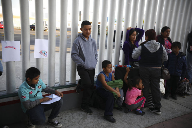 Central American migrants wait to see if their number will be called to cross the border and apply for asylum in the United States, at the El Chaparral border crossing in Tijuana, Mexico, Friday, Sept. 13, 2019. [File photo: AP]