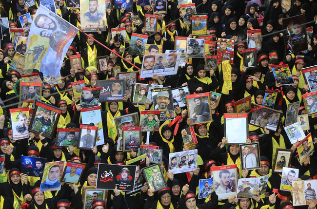 Supporters of the Lebanese Shiite Hezbollah movement carry placards with images of killed fighters as they take part in a mourning procession on the tenth day of the lunar month of Muharram, which marks the day of Ashura, in a suburb of the capital Beirut, on September 10, 2019. [Photo: AFP]