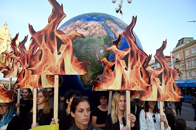 Students and activists hold up a globe as they take part during the Global Climate Strike march downtown Zagreb, Croatia, on September 20, 2019. [Photo: AFP/Denis LOVROVIC]