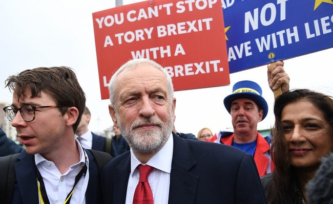 Labour Party leader Jeremy Corbyn (2-L) departs the Andrew Marr Show next to Pro EU campaigner Steve Bray (2-R) on the second day of the Labour Party Conference in Brighton, Britain, September 22, 2019. [Photo: IC]