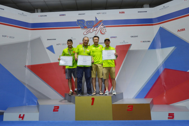 Winners of the kart race following the China-ASEAN Touring Assembly competition pose for photos in an indoor circuit in Singapore on Sep 28, 2019. [Photo provided to China Plus]