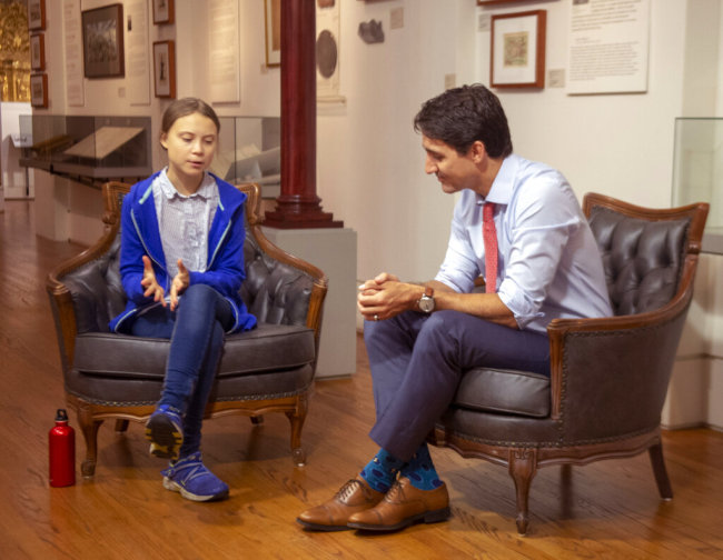 Canadian Prime Minister Justin Trudeau speaks Swedish environmental activist Greta Thunberg in Montreal on Friday, Sept. 27, 2019. Thunberg says she delivered the same message to Trudeau that she gives to all politicians -- that he needs to listen to the science and act on it. [Photo: AP]