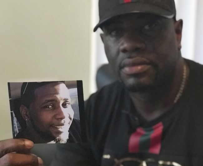 In this August 7, 2018, file, Michael McGlockton holds a photo of his son, Markeis McGlockton, who was shot dead by Michael Drejka in a parking lot dispute. [Photo: IC]