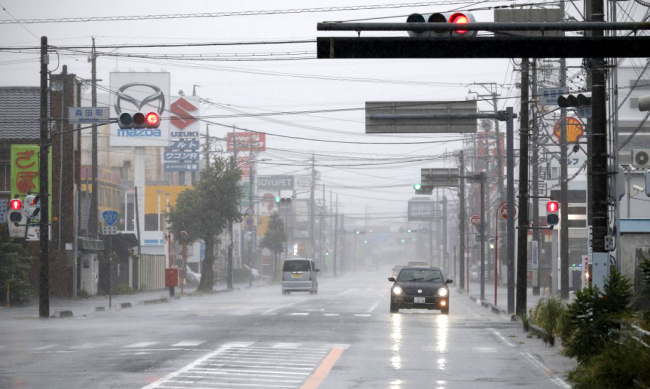 Cars travel along a main road amid high winds and rainfall in Hamamatsu, Shizuoka prefecture on October 12, 2019, ahead of Typhoon Hagibis' expected landfall in central or eastern Japan later in the evening. [Photo: AFP]