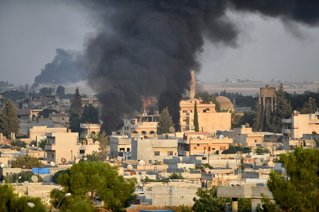 A photo taken from Turkey's Sanliurfa province, on October 9, 2019 shows smoke rises at the site of Ras al-Ayn city of Syria. [Photo: Anadolu Agency via IC]